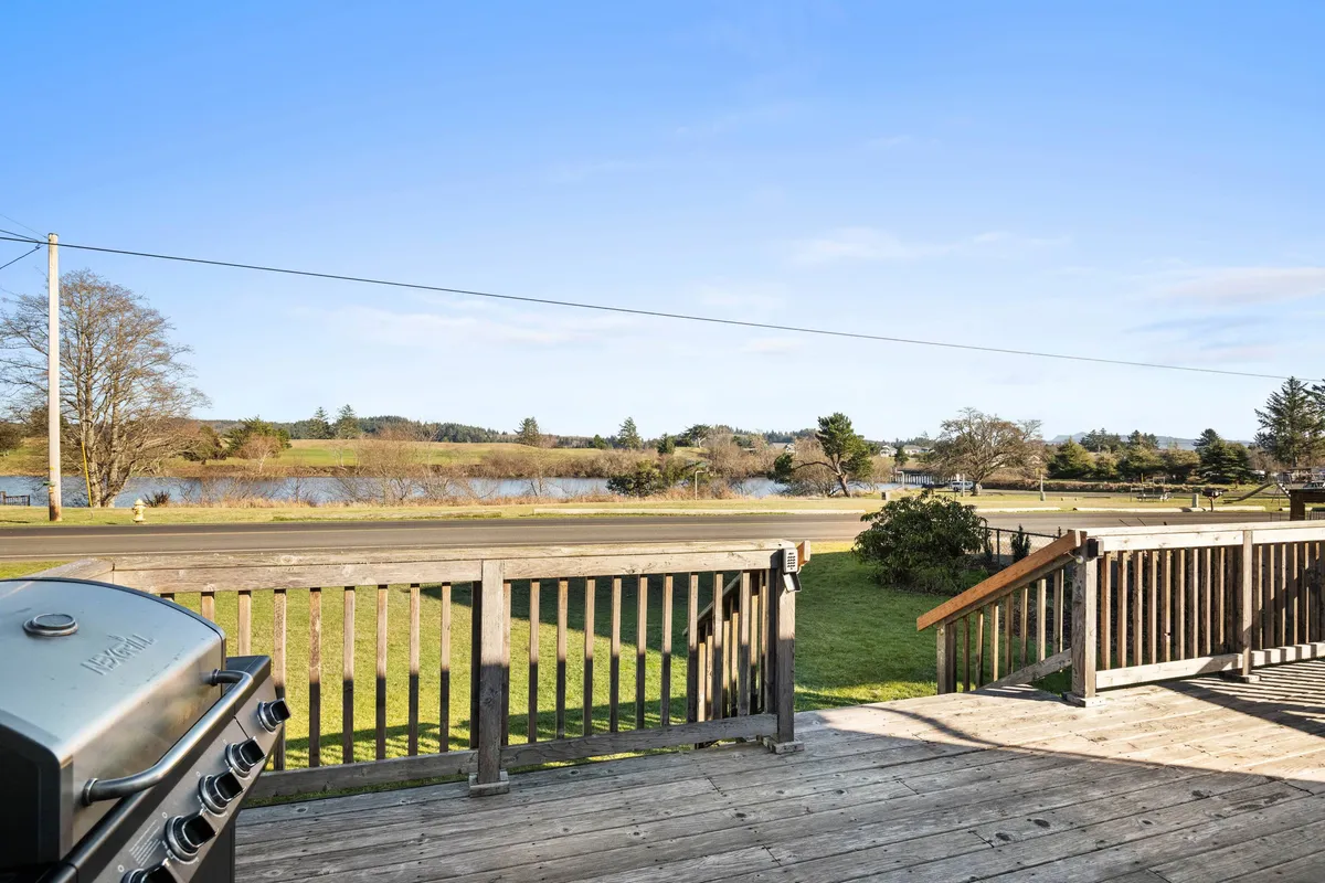 An inviting deck overlooking the water, equipped with a grill and surrounded by the scenic landscape. The space is perfect for barbecues, family gatherings, or simply relaxing while enjoying the lake view.