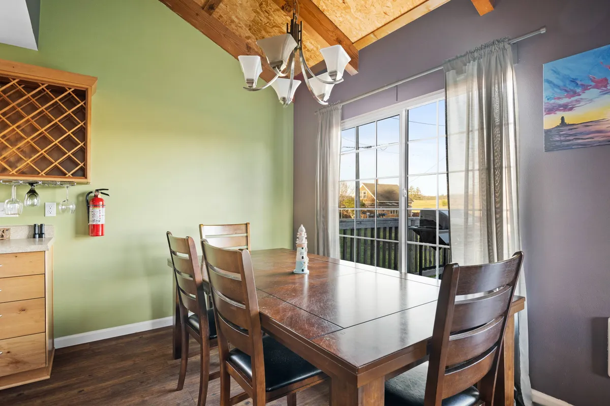 An inviting dining space with a sturdy table, elegant chandelier, and window views, ideal for family meals, celebrations, and casual gatherings. The ambiance hints at memorable shared moments and flexibility for different group sizes.